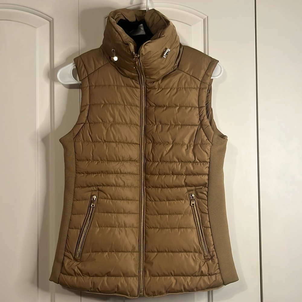 Gently used size small vest with faux fur interior and of polyester material.
